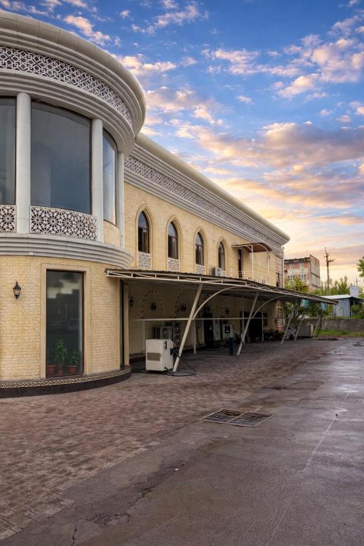 a large building with a balcony on the side of it at Shoxdiyor in Angren