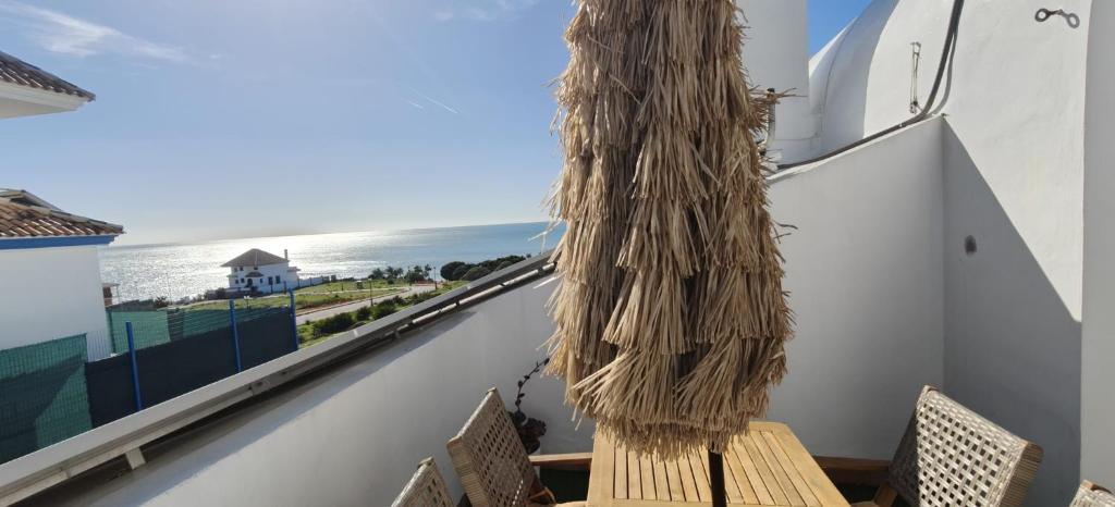 a balcony with a bench and a view of the ocean at Beautiful house with ocean views in La Cala de Mijas
