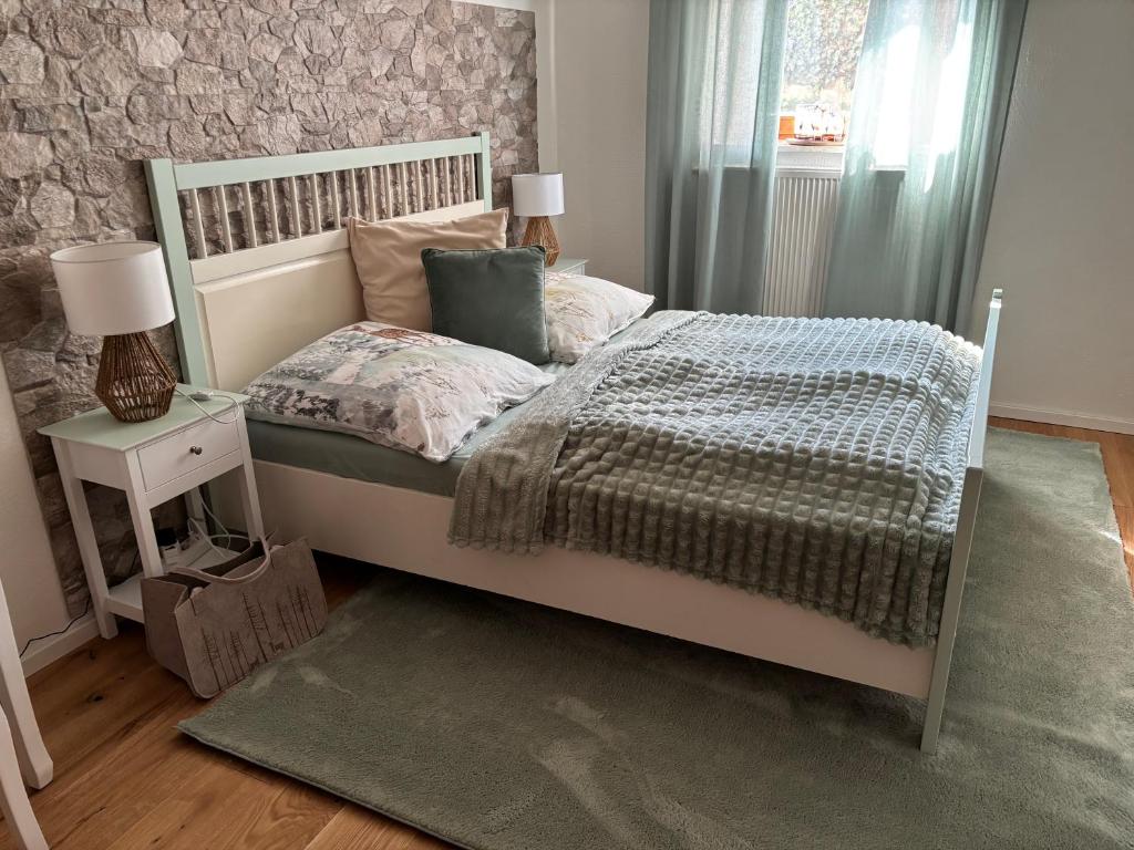 a bedroom with a bed and a table with a lamp at Grünes Stüble - Haustiere auf Anfrage in Altusried