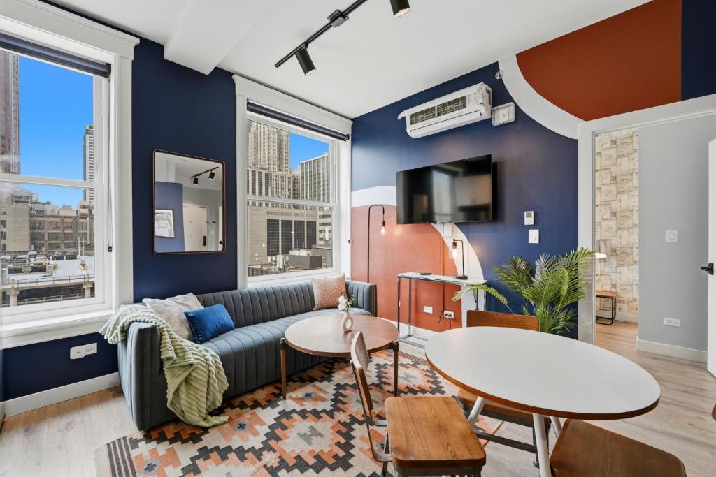 a living room with a couch and a table at The Plymouth Chicago in Chicago