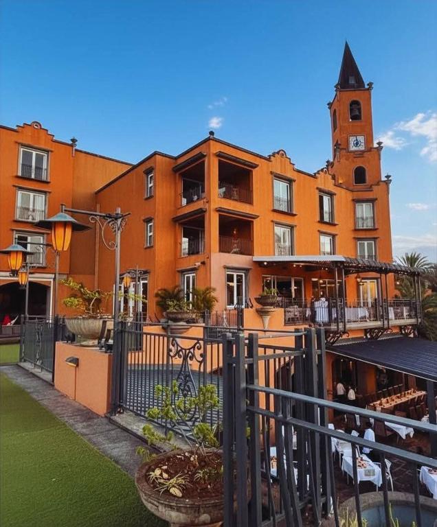 a large building with a clock tower in front of it at Port Chambly Waterside Villa in Terre Rouge