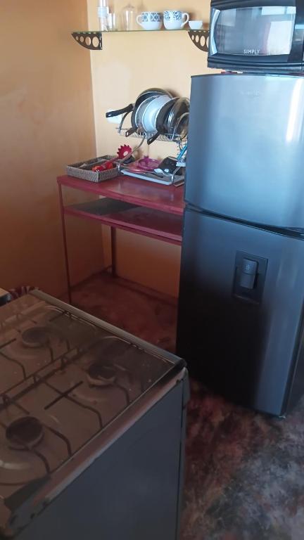 a kitchen with a stove and a refrigerator at Buena Vista in Taganga