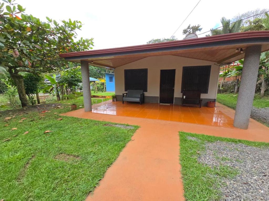 a patio of a house with a roof at La Martha in Sarapiquí