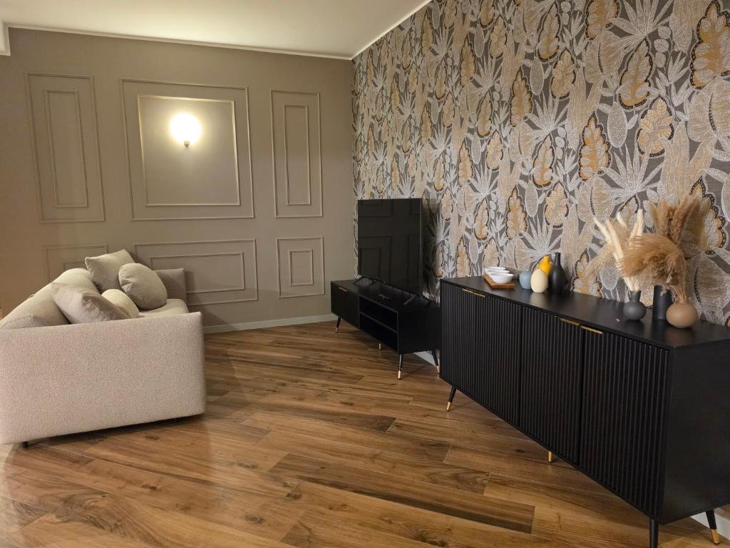 a living room with a couch and a television at Gravina Boutique Apartment in Gravina in Puglia
