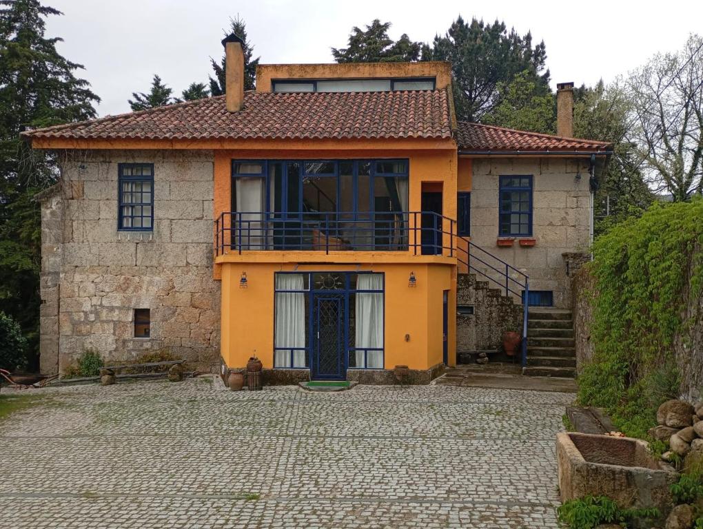 an old stone house with a blue door at Quinta Da Lagoa GuestHouse in Vila Real