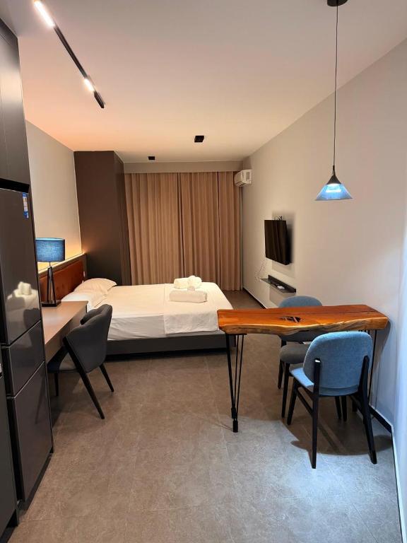 a bedroom with a bed and a table and chairs at Casa Del Sol Studio - Shengjin in Shëngjin