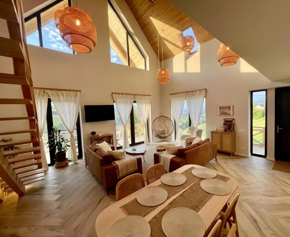 a living room with a table and a couch at Casa Ido sat Pestera Moieciu in Peştera