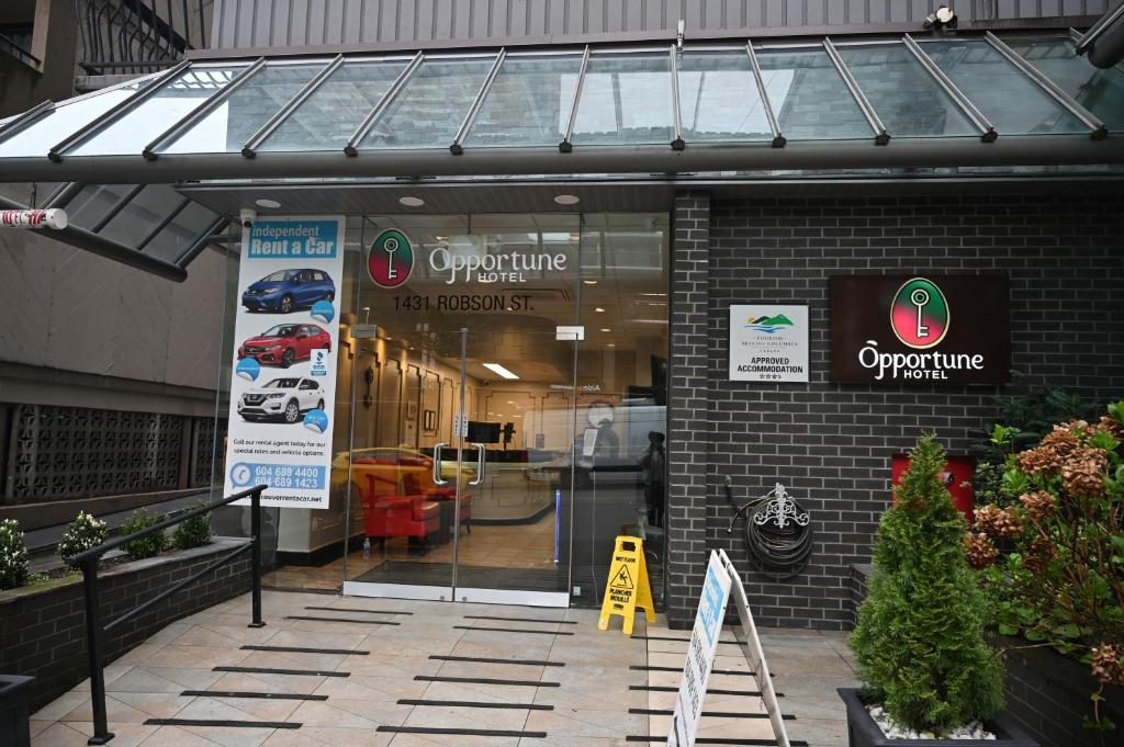 a store front with a glass door in a building at Hotel Opportune in Vancouver