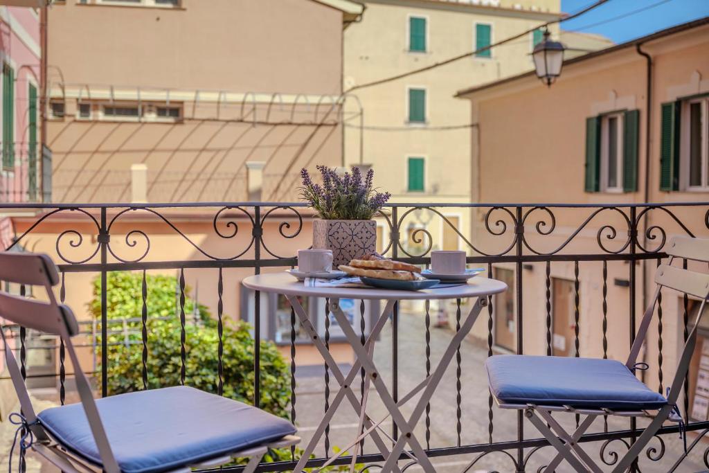 a table and two chairs on a balcony at Bilocale affacciato sul budello a 30 mt dal mare in Laigueglia