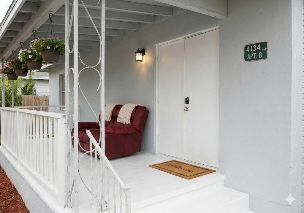 a red chair sitting on the porch of a house at GpL 4134 Cozy & Spacious 4BR Shared House in Fort Myers