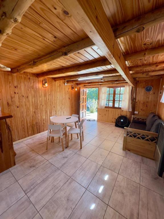 a large room with a table and chairs in a cabin at Cielo Azul 2 in Villa Pehuenia