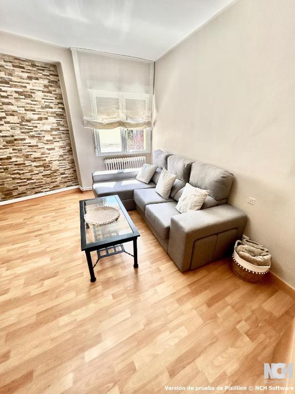 a living room with a couch and a table at Carbonería 4 in Soria