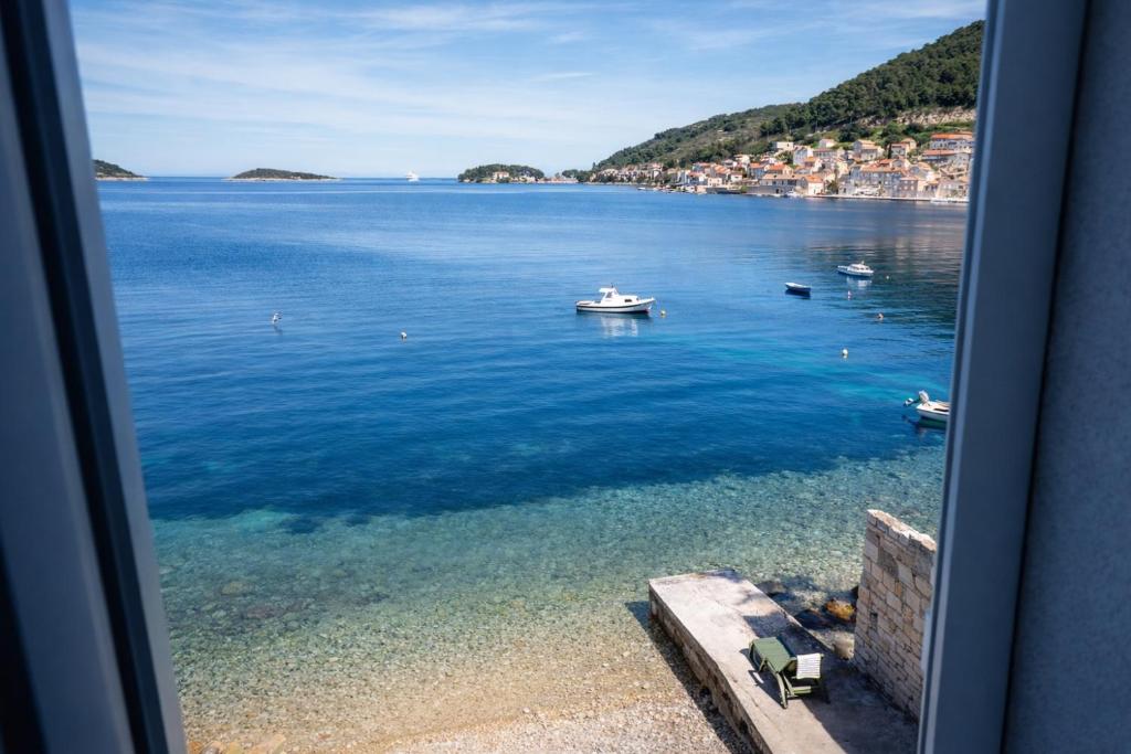 a view of a large body of water with boats at The Wave Seafront Apartment Vis in Vis