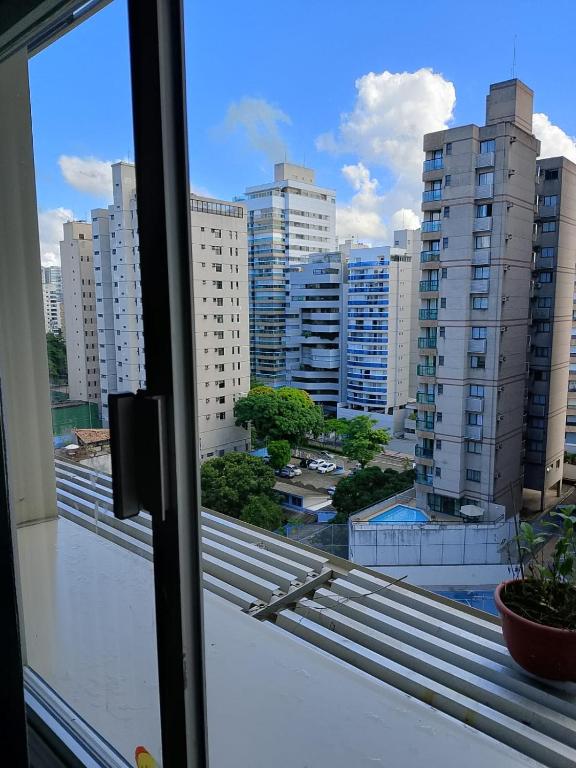 a view of a city from a window at Quarto no apartamento do anfitrião na Praia do Canto in Vitória