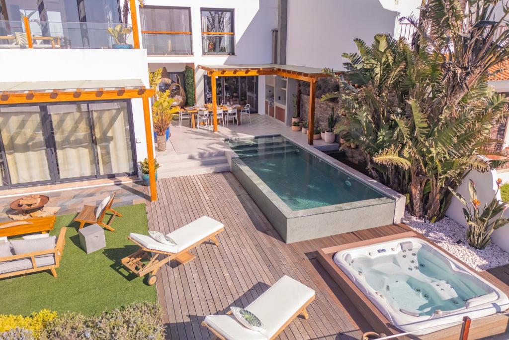 a house with a hot tub in the middle of a yard at Ericeira Ocean View Villa in Ericeira