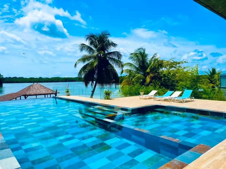 a swimming pool with a view of a body of water at villa rach in Assinie