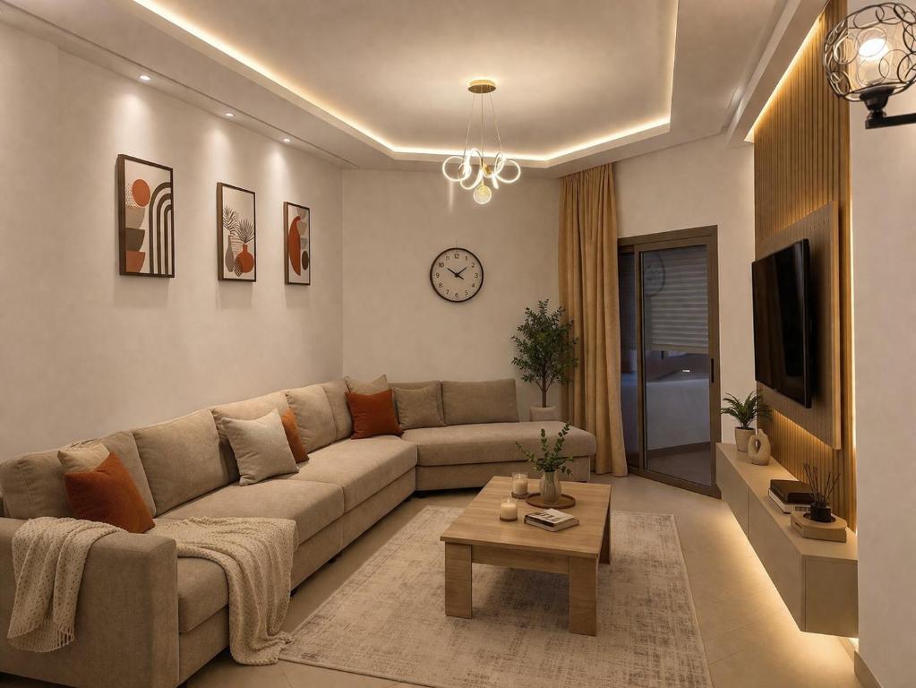 a living room with a couch and a table at Asilah Ocean View Residence in Asilah