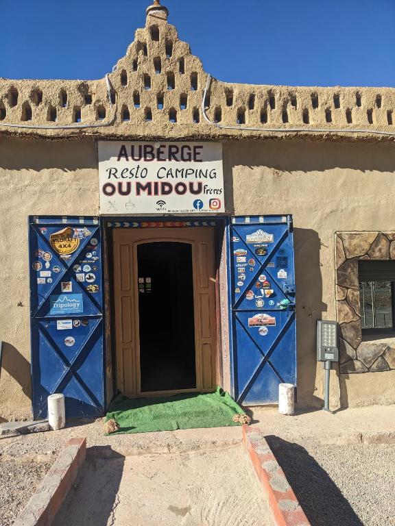 an entrance to a building with a sign on it at Auberge Restaurant Oumidou in Agoudal