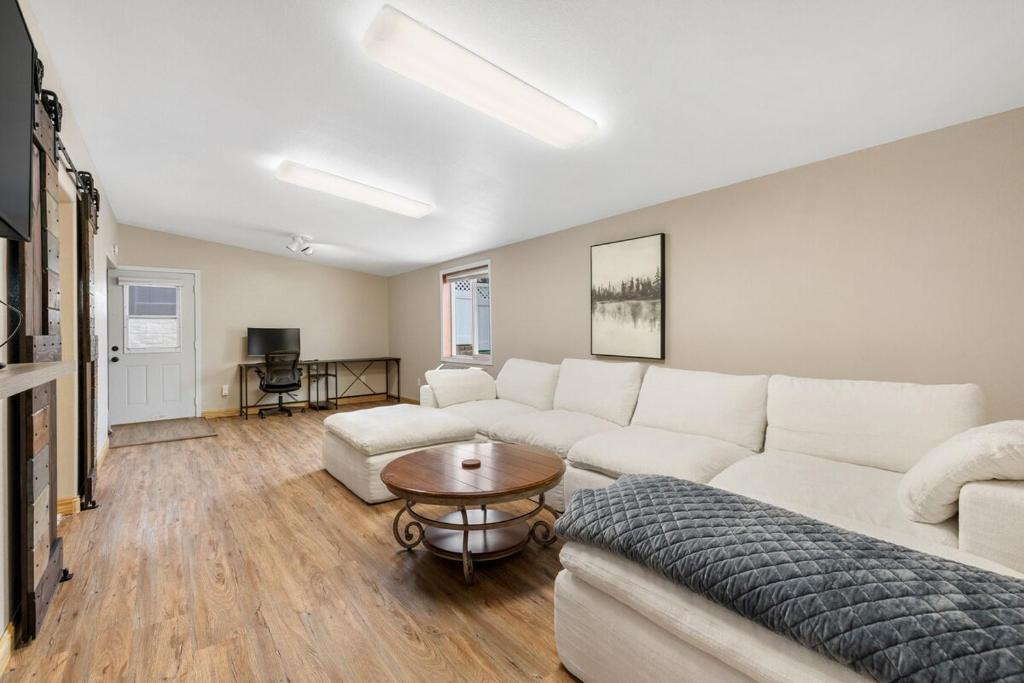 a living room with a white couch and a table at Mt Rushmore Duplex in Rapid City