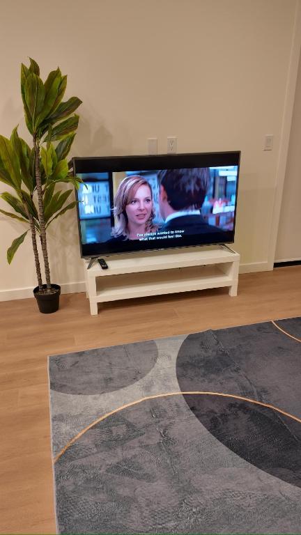 a flat screen tv sitting in a living room at Central Luxe in Surrey