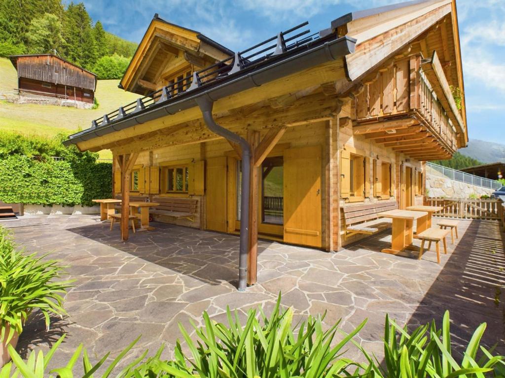 a building with a patio with benches and tables at Bergsehnsucht in Hippach