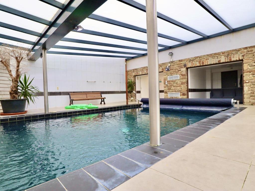 an indoor swimming pool with a pergola at Le Congo in Ochamps