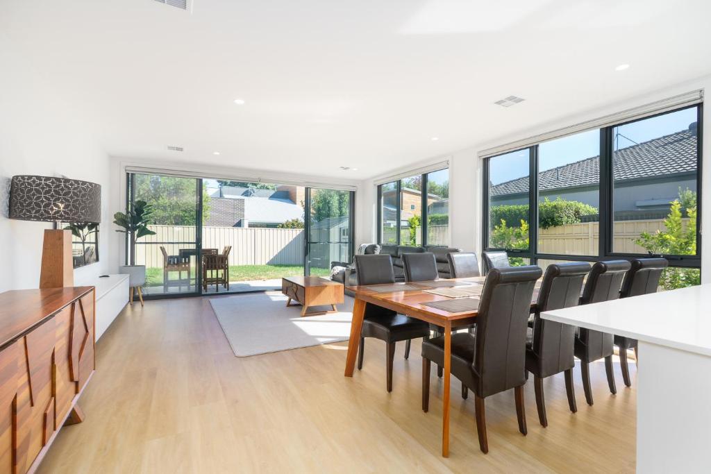 a kitchen and dining room with a table and chairs at Mid-Century Home Near Hospital and Woden - Hosted by Canstay in Phillip