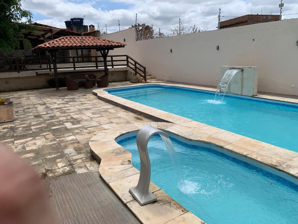 a large swimming pool with a water fountain at Espaço Victoria in Caruaru