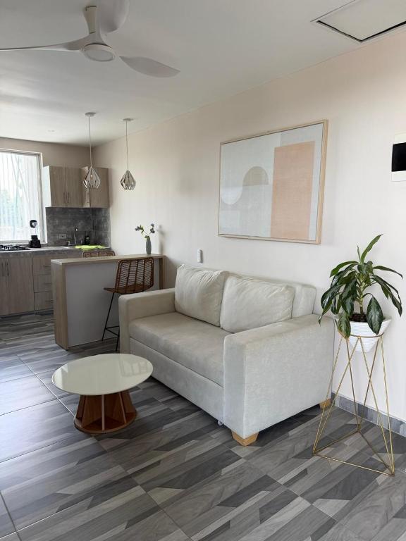 a living room with a couch and a table at Amoblados la 19 in Ríohacha