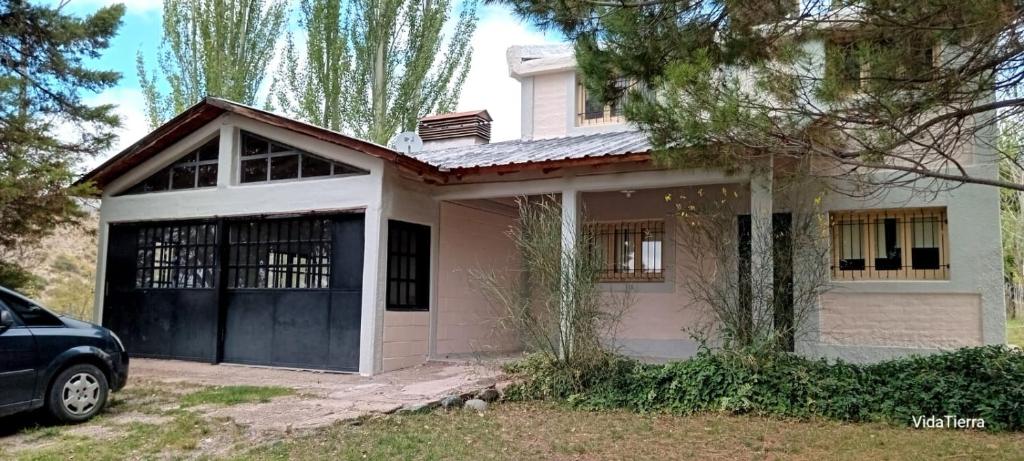 a house with a car parked in front of it at Casa Nur in Potrerillos