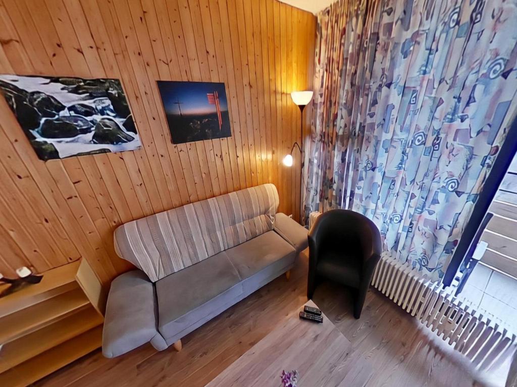 a living room with a couch and a window at Studio Sebastian mit Pool und Sauna in Freyung