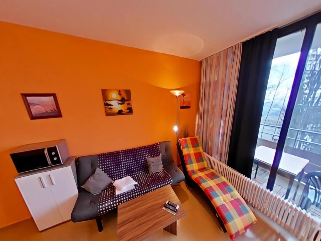 a small living room with a couch and a table at Studio Rainer mit Pool und Sauna in Freyung