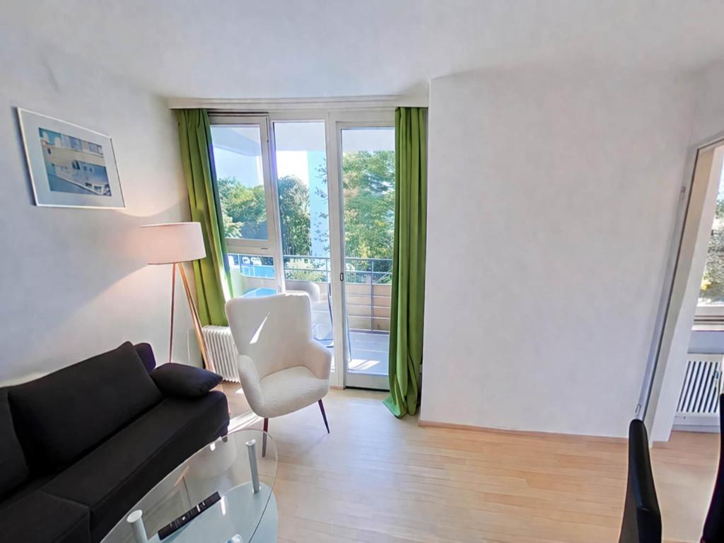 a living room with a couch and a chair at Studio Roswitha mit Pool und Sauna in Freyung