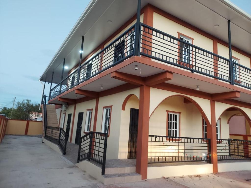 a building with a balcony on the side of it at Sotera's Guest House in Corozal
