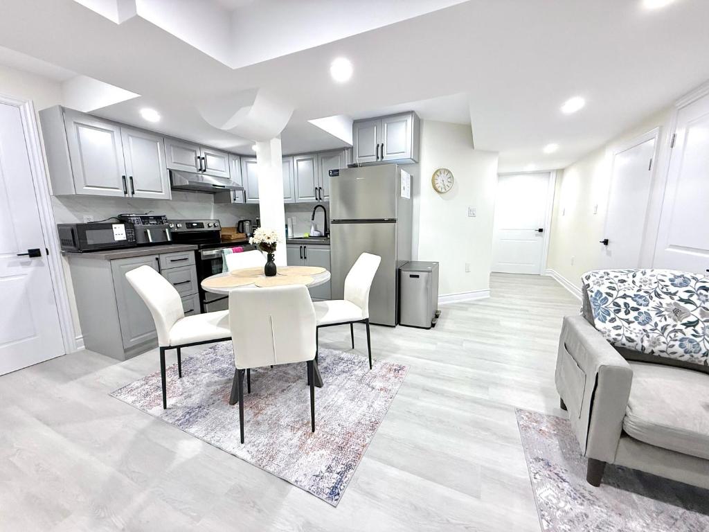 a kitchen and living room with a table and chairs at Modern 2BR Suite Private Entrance Parking New in Woodstock