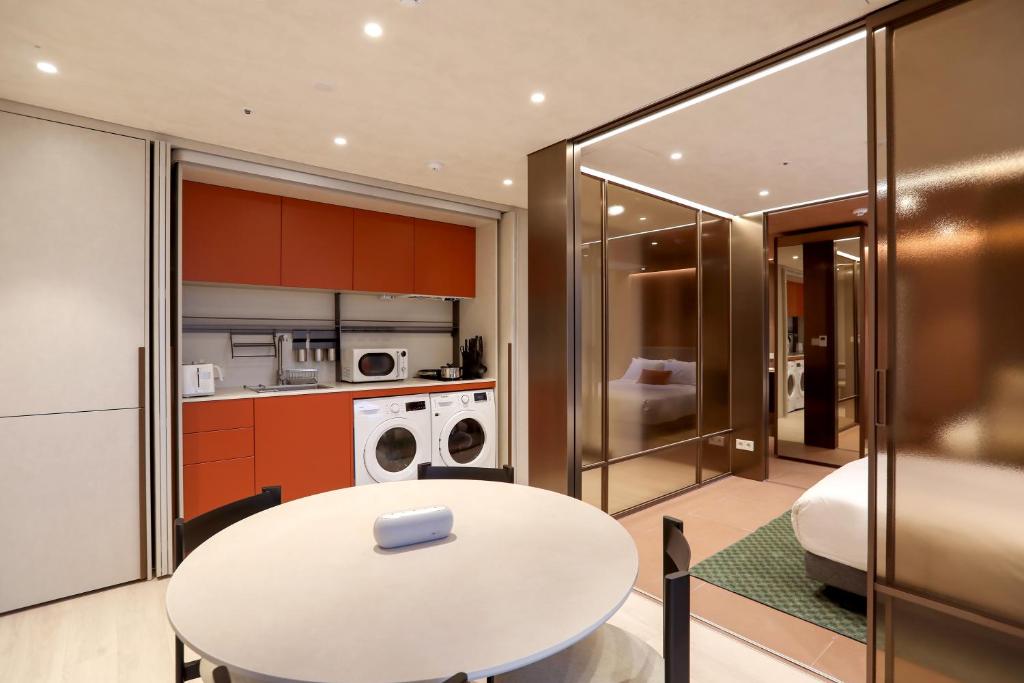 a kitchen with a white table in a room at ASTY Cabin Seoul Serviced Residence in Seoul