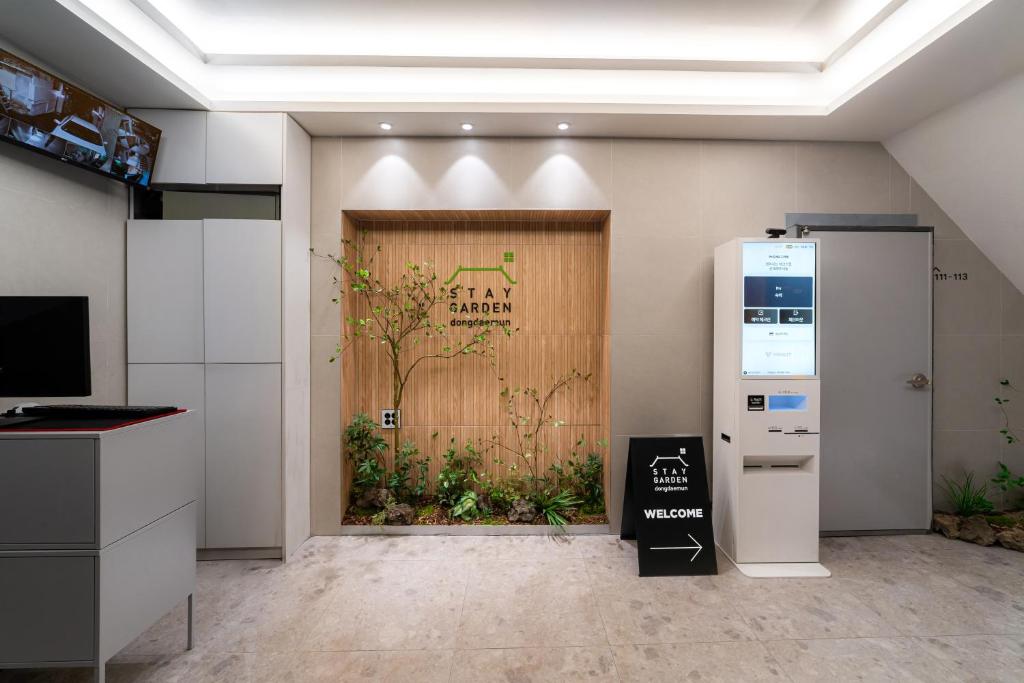 a kitchen with a door with a horse on it at Dongdaemun Stay Garden in Seoul