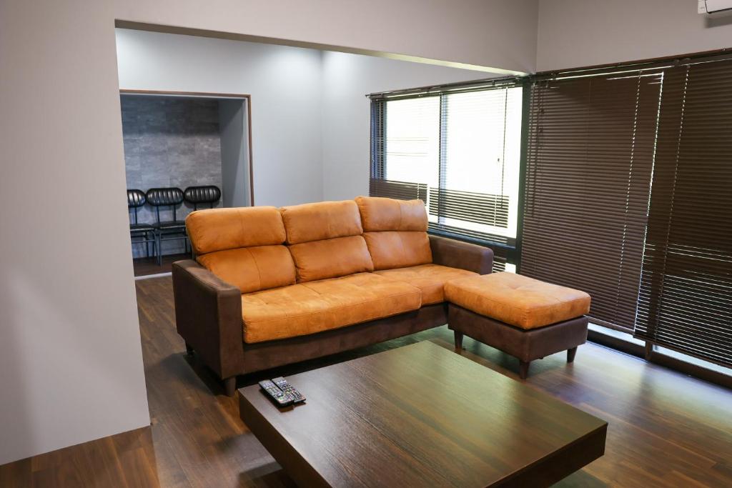 a living room with a couch and a coffee table at Udo Torii Gate Stay Yoi in Nichinan