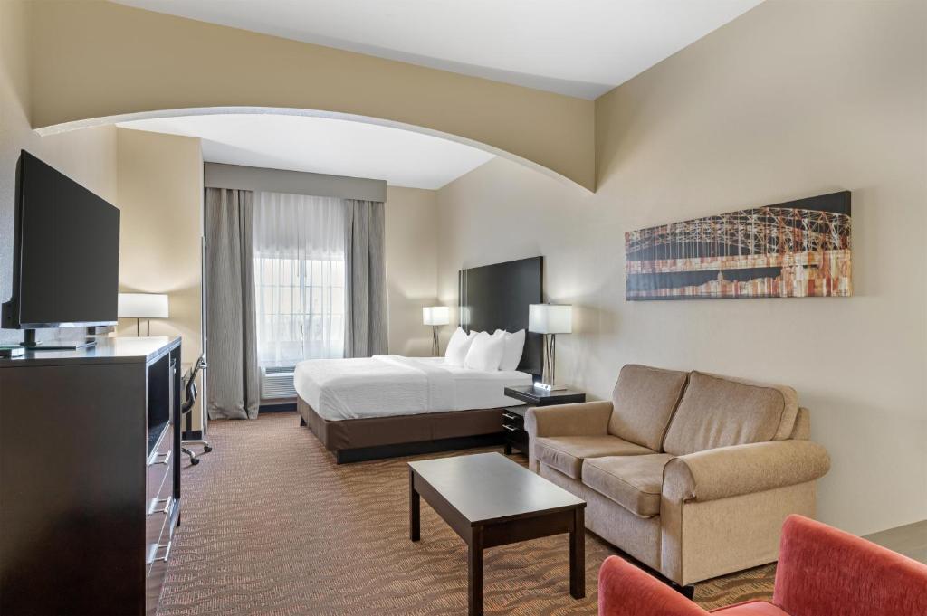 a hotel room with a bed and a couch and a bed at Best Western Plus Capital Inn in Jefferson City