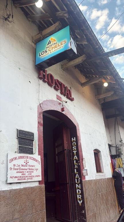 a building with a sign over the door of a hospital at Hostal Los Cheles in León