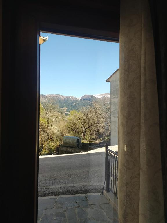 an open door to a view of a road at Metsovo apartment in Metsovo