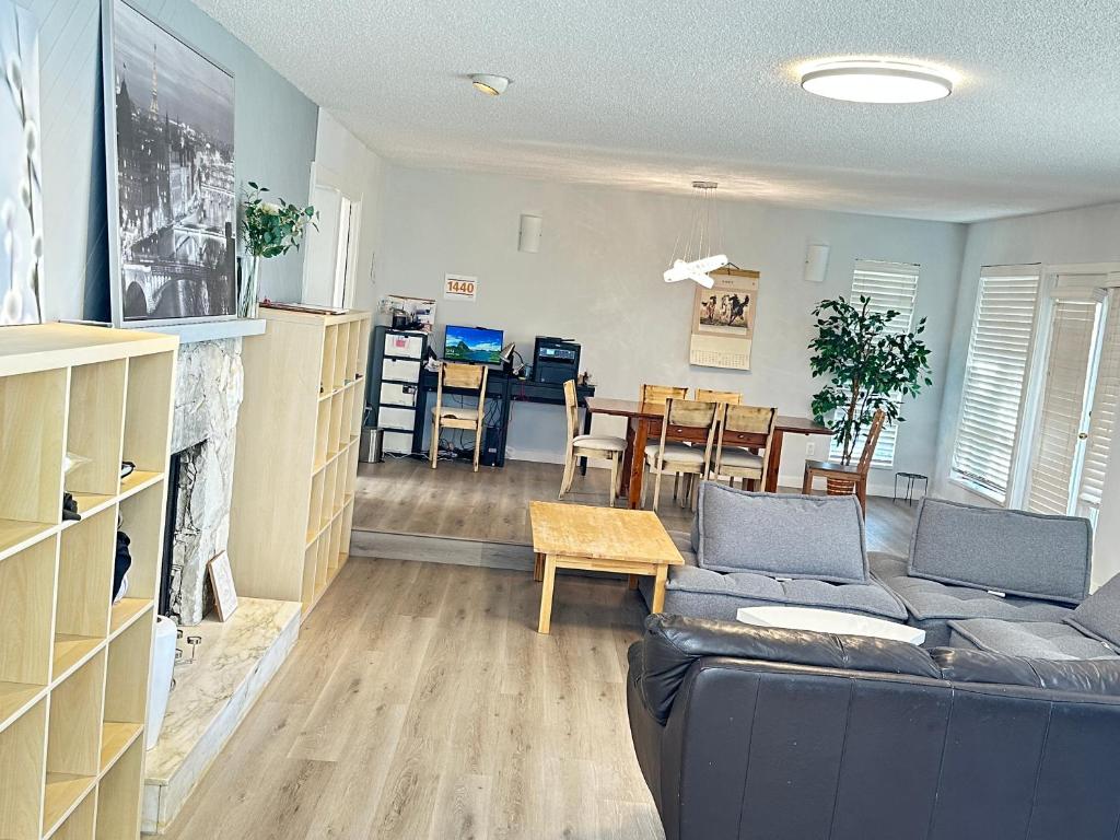 a living room with a couch and a fireplace at Joe West Vancouver Lodge in West Vancouver