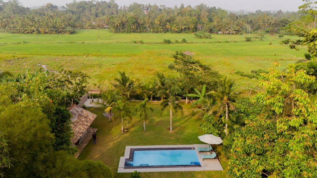 an aerial view of a villa with a swimming pool at Idam Villa in Akmimana
