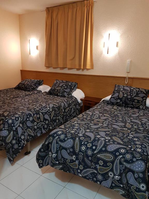 Postel nebo postele na pokoji v ubytování Hotel Arinsal