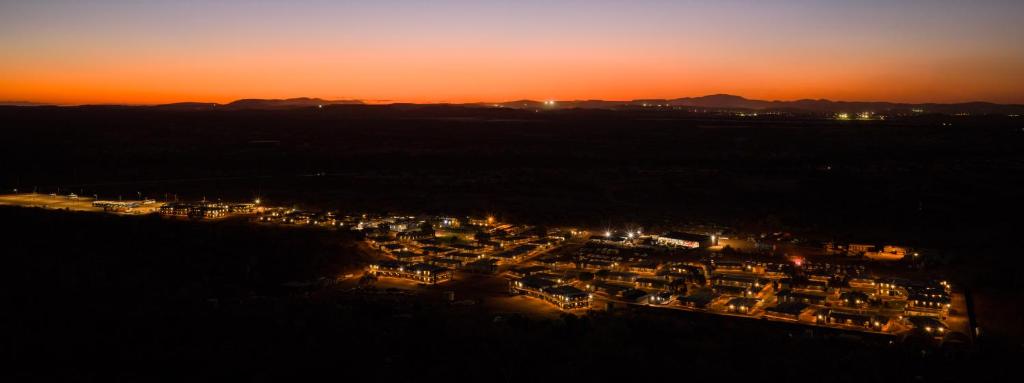 an aerial view of a city lit up at night at Oasis Newman in Newman