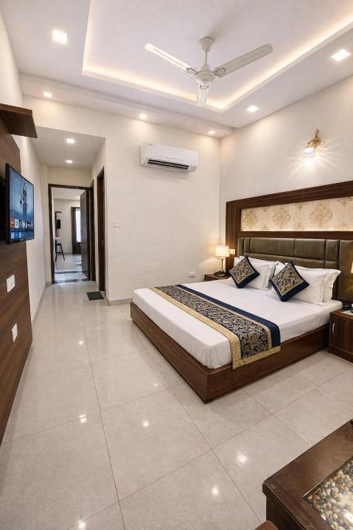 a bedroom with a large bed in a room at The WoodLuck Zirakpur Chandigarh - Sidham Group of Hotels in Chandīgarh