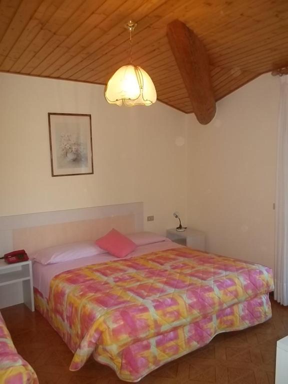 Postel nebo postele na pokoji v ubytování Hotel Residence La Rosa