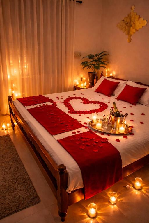 a bedroom with a large bed with candles on it at Best Homestay in Alappuzha 4 BR- LAYANILA in Alleppey