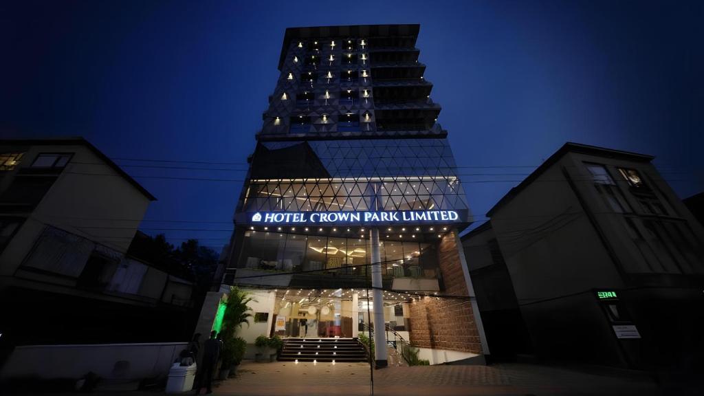 a tall building with a sign that reads a hotel room rang united at Hotel Crown Park Ltd in Sylhet