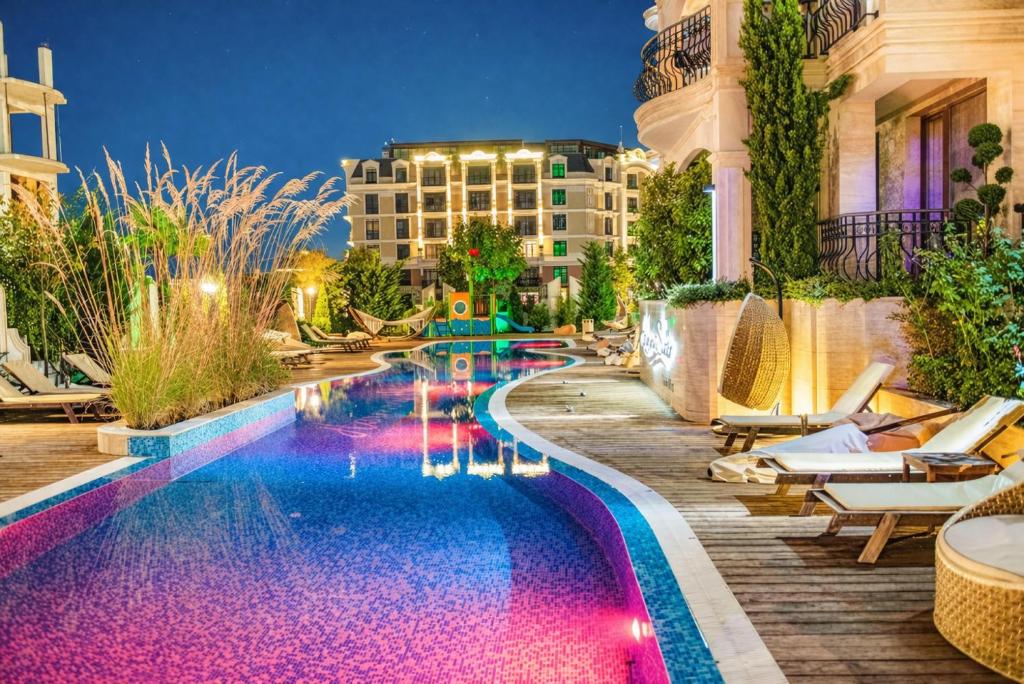 a pool at a hotel with chairs and a building at Harmony 20 Sveti Vlas Private Apartment 211 in Sveti Vlas